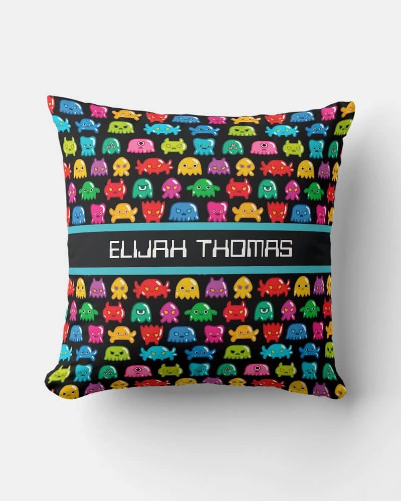Personalized pillow with a colorful monster pattern and the name Elijah Thomas.