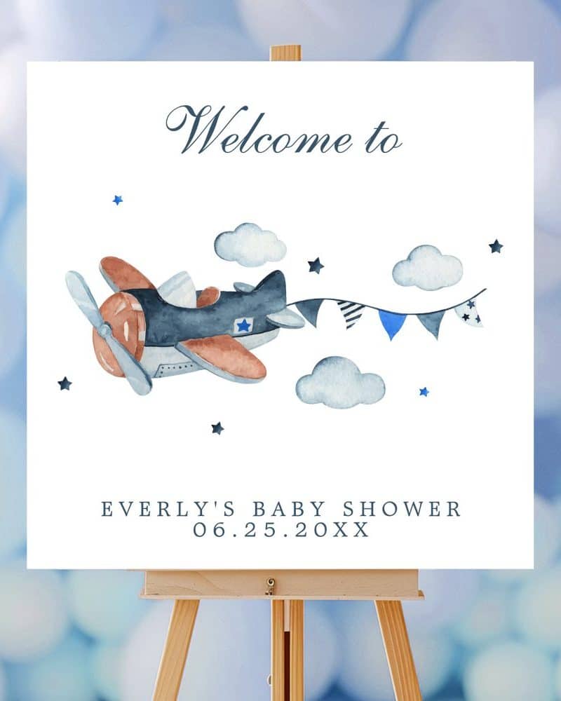 Welcome sign for Everly's baby shower featuring a watercolor illustration of a plane pulling a banner.