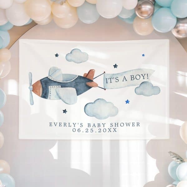 A White Rectangular Sign With A Watercolor Illustration Of A Plane Pulling A Banner That Reads Its A Boy. Below The Plane Is Text That Says Everlys Baby Shower And A Date.