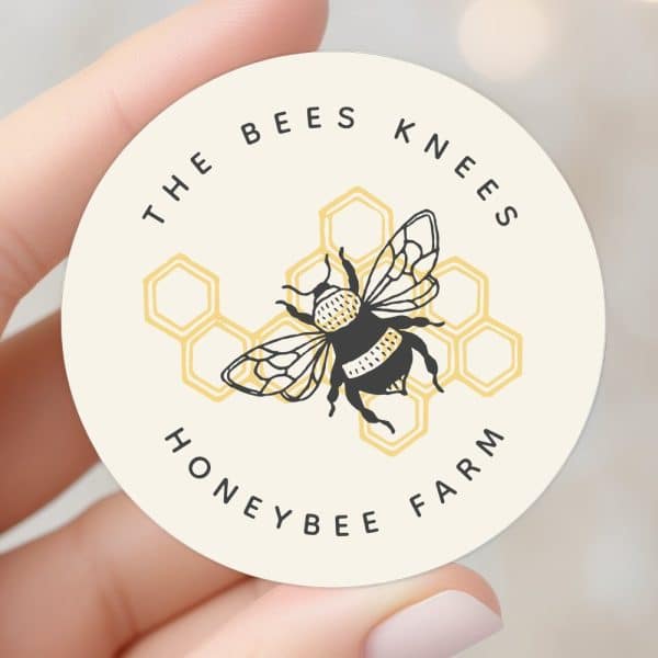 A Round Sticker Featuring A Bumblebee Illustration Centered On A Honeycomb Graphic. The Text &Quot;The Bees Knees Honeybee Farm&Quot; Circles The Design.