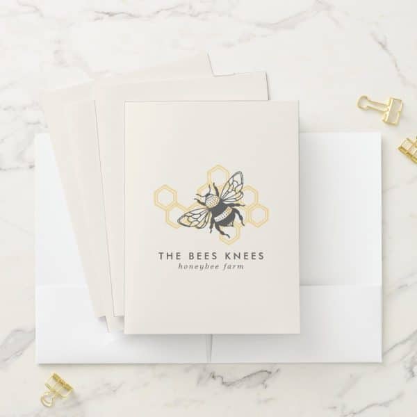 A Honeybee Farm Logo Featuring A Bumblebee In A Honeycomb. The Bees Knees Honeybee Farm Is Written Below.