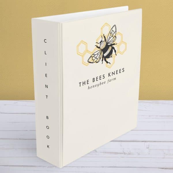 White Three-Ring Binder With The Bees Knees Honeybee Farm Logo: A Black Bee On A Yellow Honeycomb.