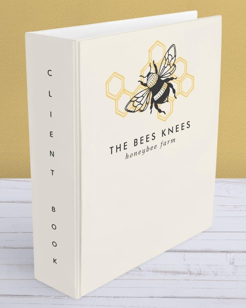 White three-ring binder with The Bees Knees honeybee farm logo: a black bee on a yellow honeycomb.