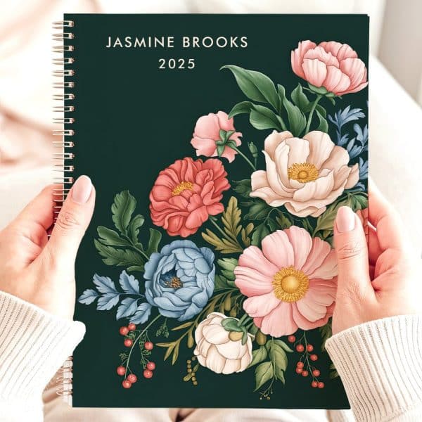 A 2025 Planner With A Dark Green Cover Featuring A Floral Bouquet Design.