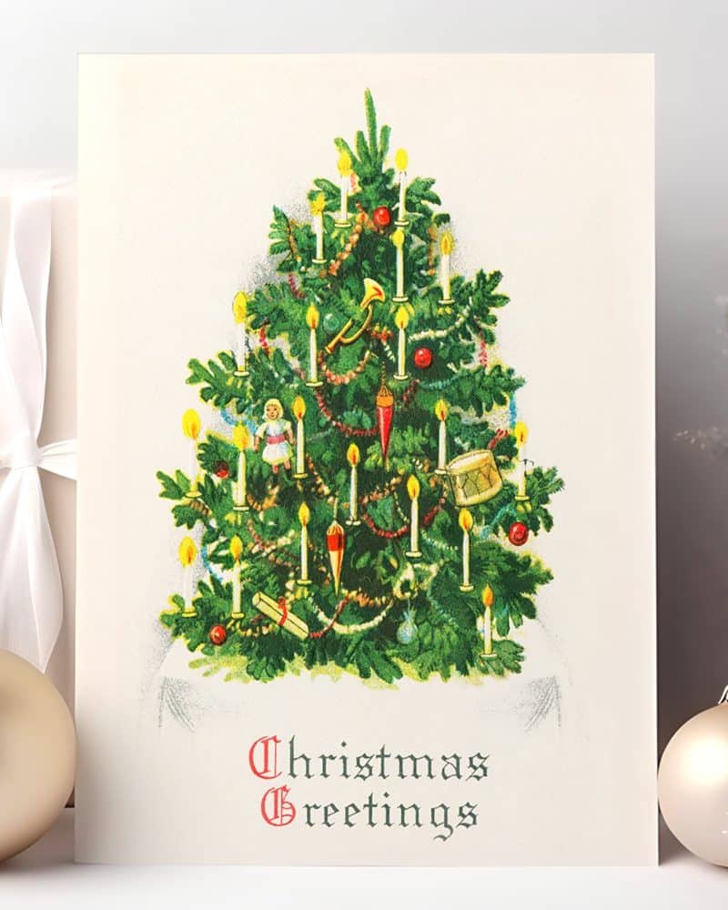 Vintage Christmas card depicting an ornamented Christmas tree with lit candles.