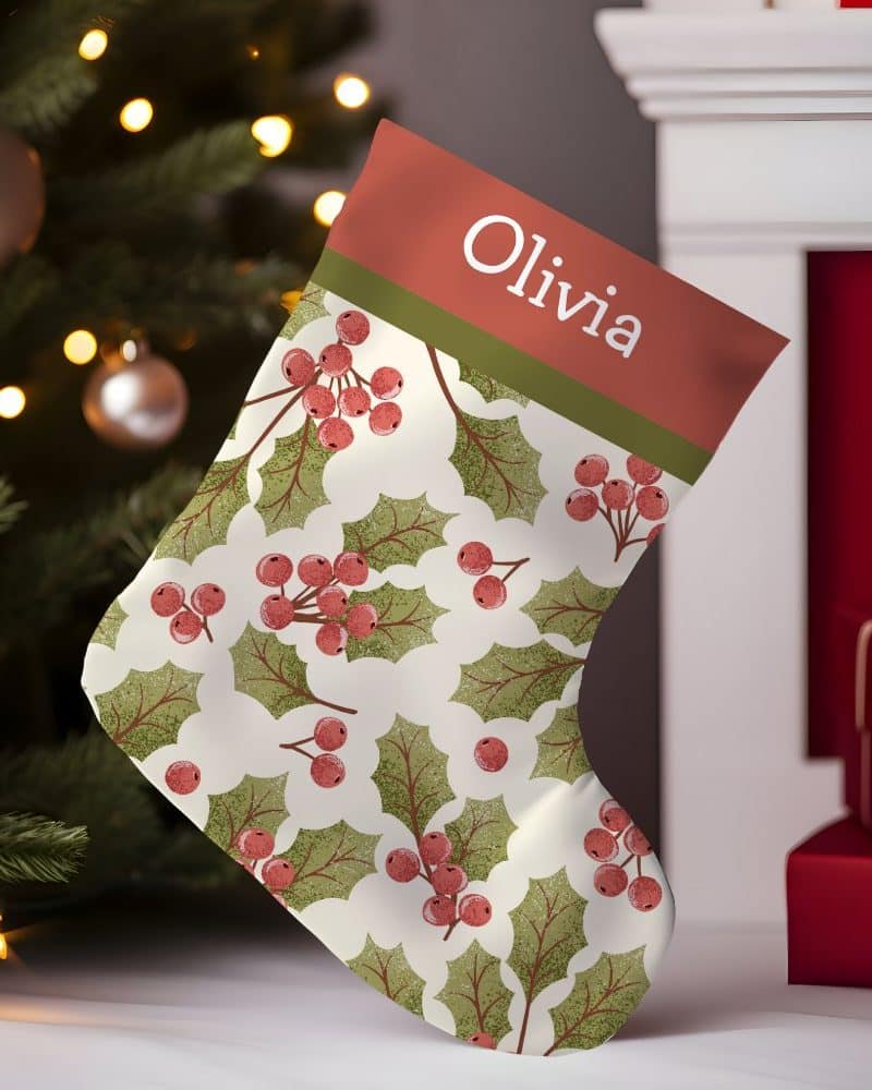 Personalized Christmas stocking with a holly berry pattern and the name Olivia.