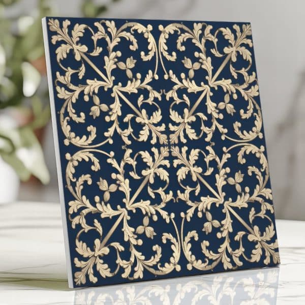 Square Tile Featuring A Navy Blue Background And A Gold Ornate Floral Pattern.