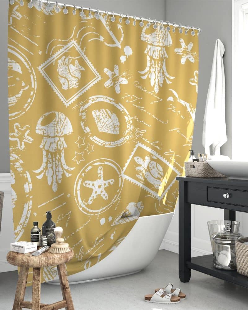Mustard yellow shower curtain with a white nautical pattern of jellyfish, starfish, seashells, and postage stamps.
