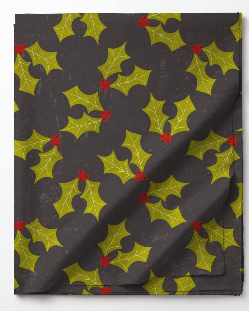 Dark gray fabric with a repeating pattern of yellow holly leaves and red berries.