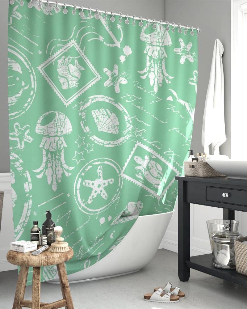 Mint green shower curtain with a white sea life and postage stamp design.