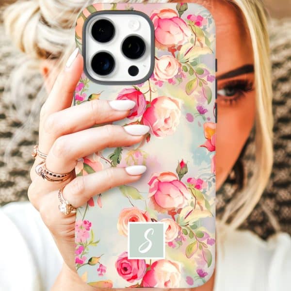 Woman Holding Iphone Case With Floral Design And Monogram.