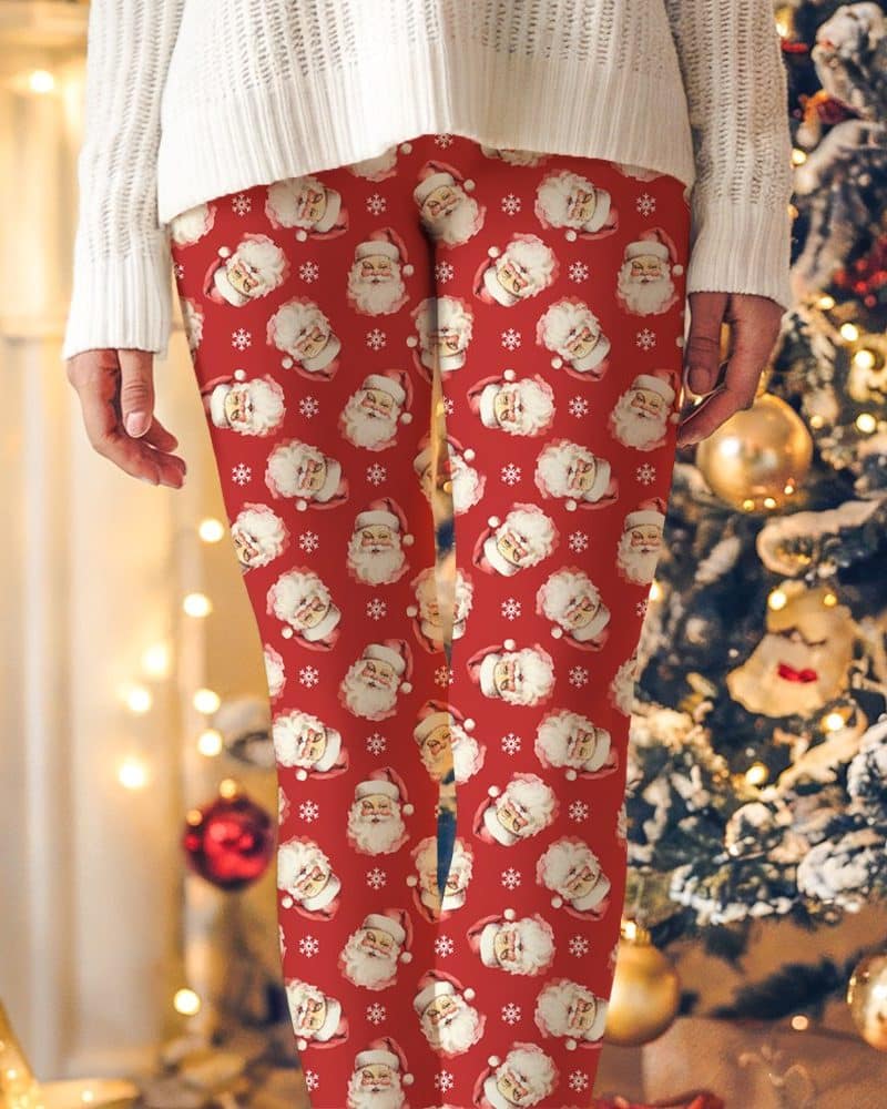 Red leggings with a repeating pattern of Santa Claus faces and snowflakes.