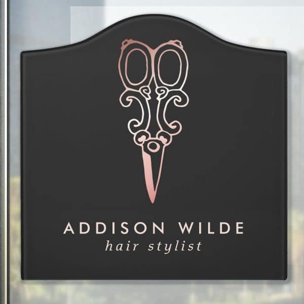 Black Rectangular Sign With Rounded Top, Featuring A Rose Gold Pair Of Ornate Scissors And The Text Addison Wilde Hair Stylist.
