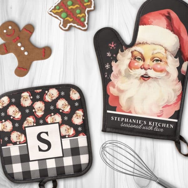 Two Christmas Oven Mitts; One Is A Large Oven Mitt Featuring A Vintage Santa Claus Illustration And Personalized Text, The Other Is A Smaller Pot Holder With A Repeating Santa Pattern And A Monogram.
