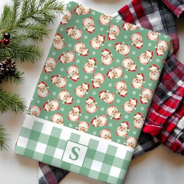 Green And White Gingham Wrapping Paper Featuring A Repeating Pattern Of Vintage Santa Claus Illustrations. A Monogrammed Initial S Is In The Lower Section.