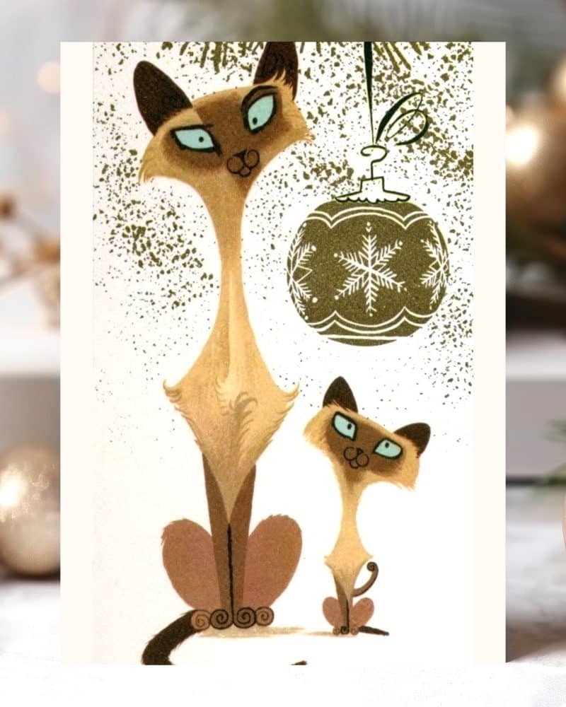 Christmas card featuring two stylized Siamese cats sitting near a hanging ornament.