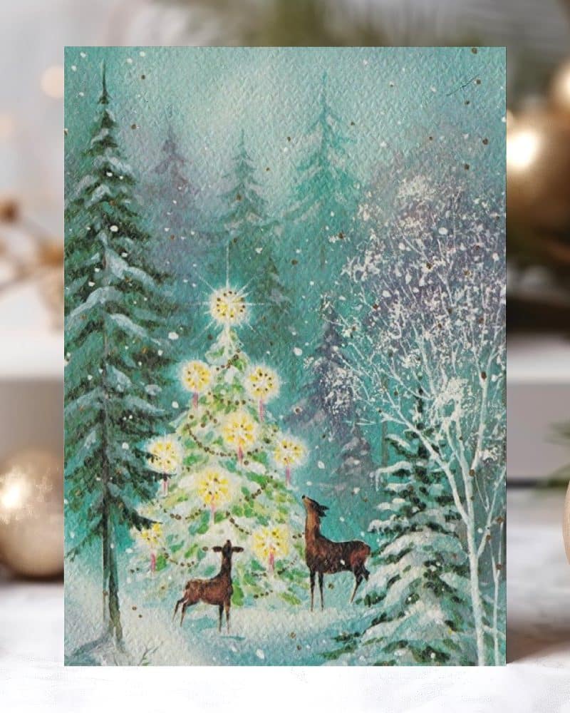 Painting of two deer gazing at a glowing Christmas tree in a snowy forest.