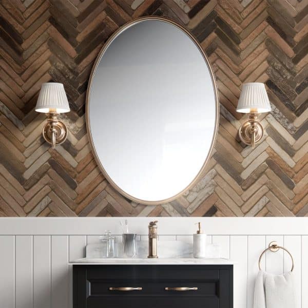 Oval Mirror With Gold Frame Above A Bathroom Vanity.