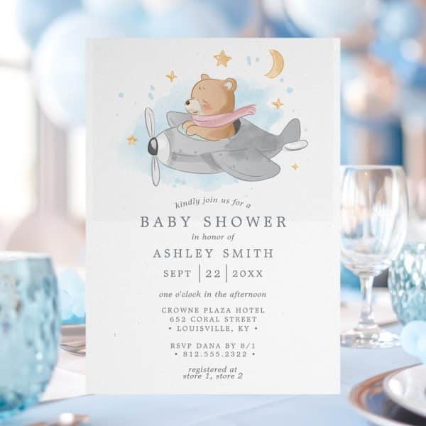 Baby Shower Invitation Featuring A Watercolor Illustration Of A Teddy Bear In A Plane.