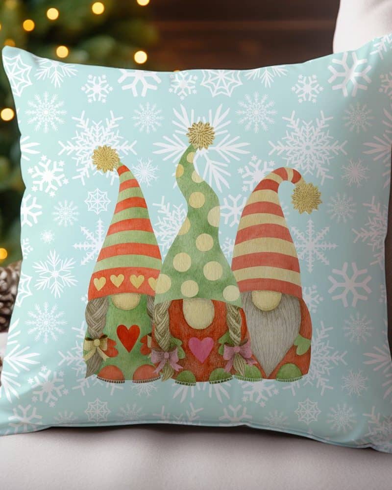 Throw pillow with three gnomes and snowflake pattern.