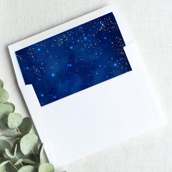 White Envelope With A Navy Blue Liner Featuring Gold Glitter Stars.
