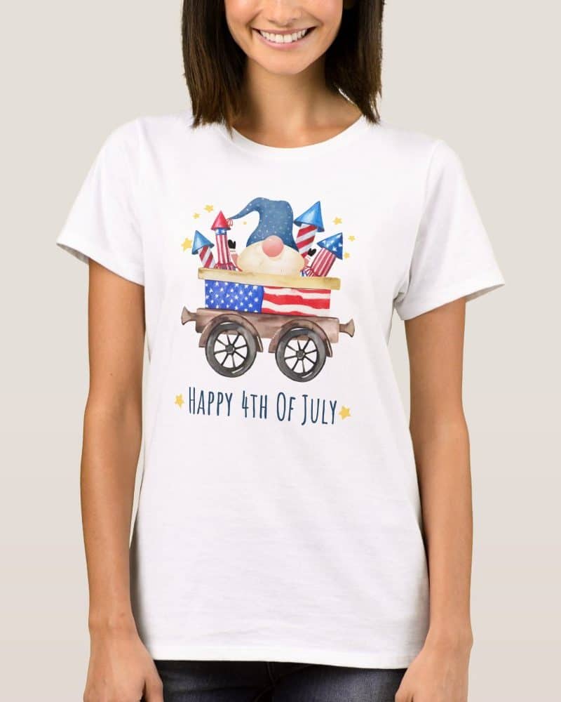 White t-shirt featuring a patriotic gnome in a wagon with fireworks.