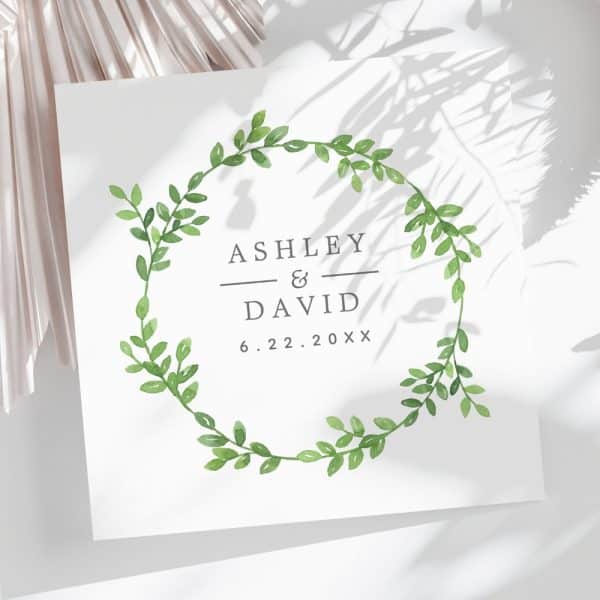 Wedding Announcement With Ashley And David'S Names And Date, Framed By A Leafy Wreath.