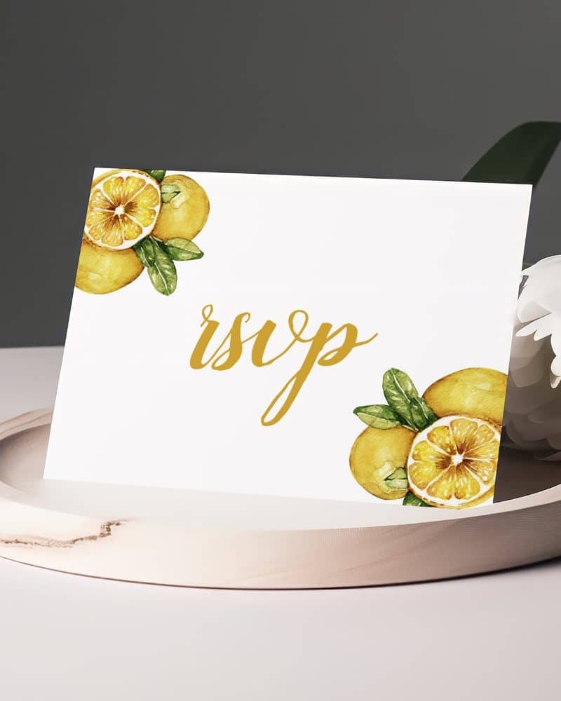 White RSVP card with gold lettering and watercolor lemons.