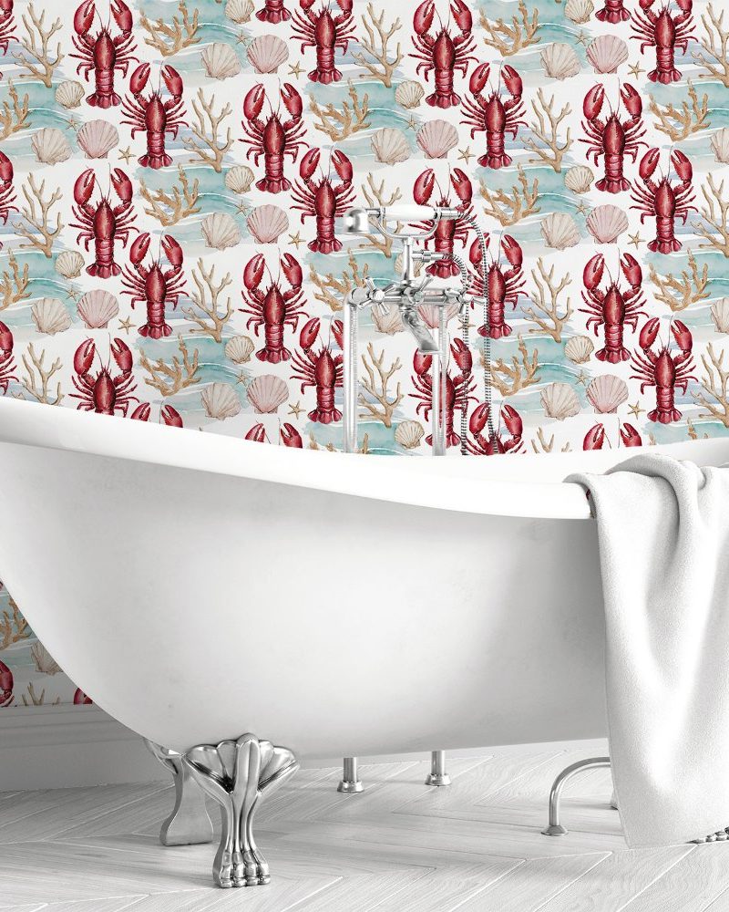 White clawfoot bathtub against a wall with a repeating pattern of red lobsters, seashells, and coral.