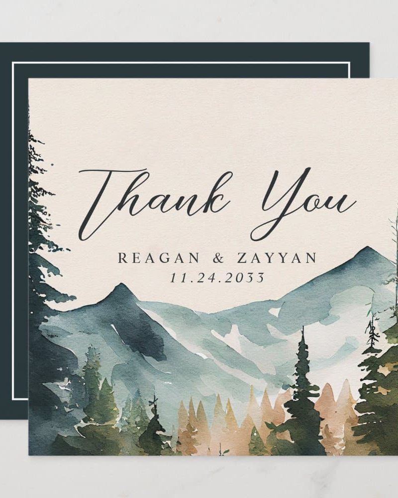 A watercolor painting of mountains and pine trees on a cream thank you card with the names Reagan & Zayyan and the date 11.24.2033.