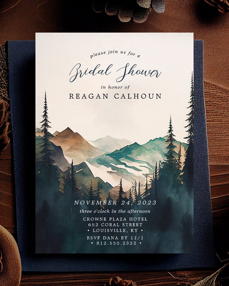 Bridal shower invitation for Reagan Calhoun, featuring a watercolor painting of mountains and pine trees.