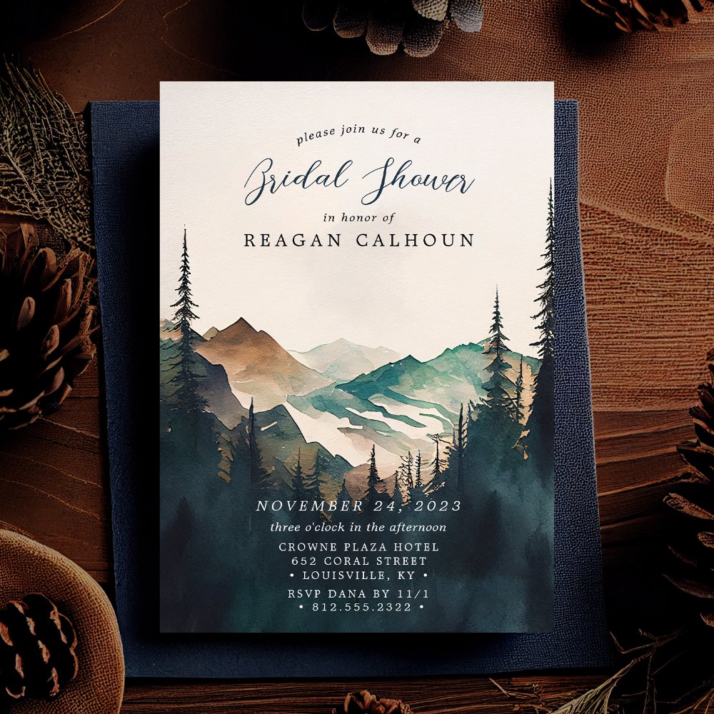 Bridal shower invitation for Reagan Calhoun, featuring a watercolor painting of mountains and pine trees.