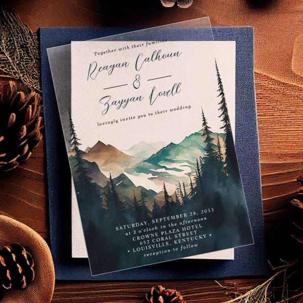 Wedding Invitation Featuring A Watercolor Painting Of Mountains And Pine Trees.