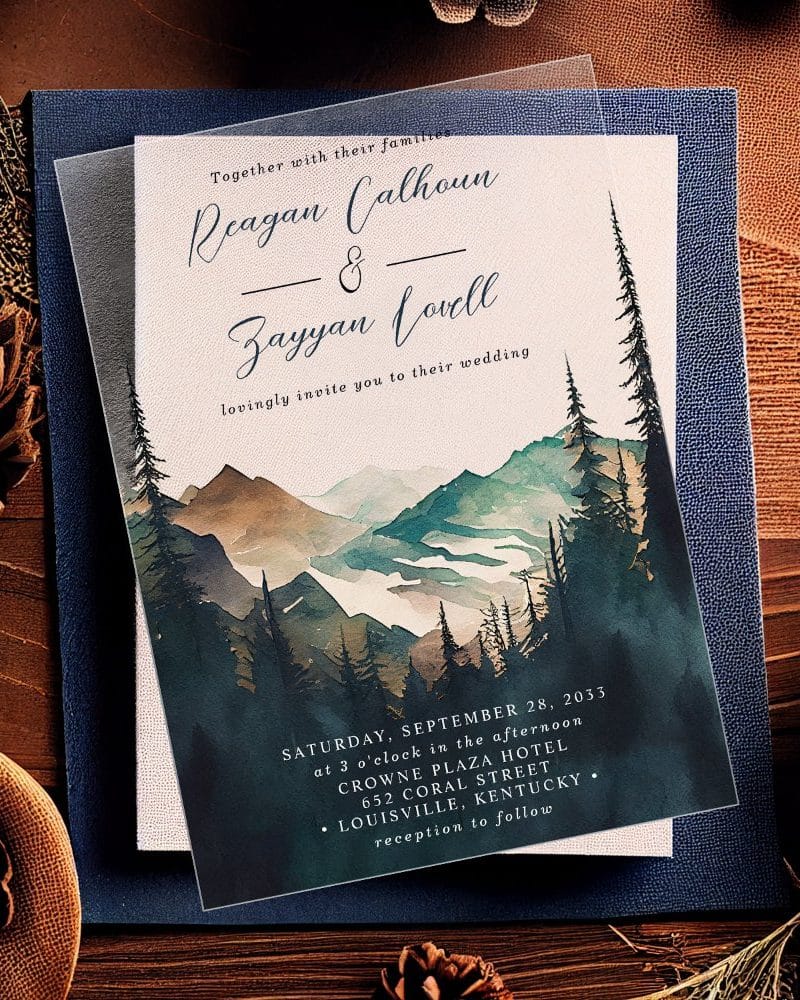 Wedding invitation featuring a watercolor painting of mountains and pine trees.