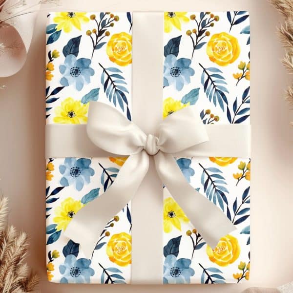 Gift Box With A Floral Design In Yellow And Blue, Tied With A Light Beige Ribbon.