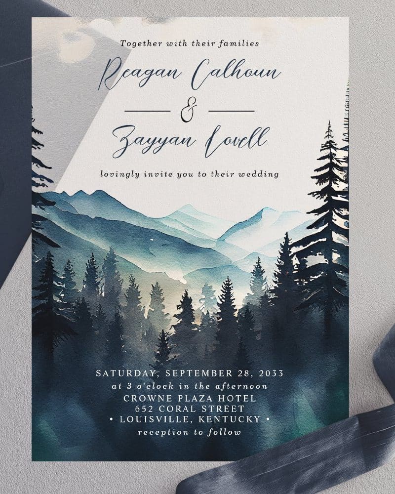 Wedding invitation with watercolor painting of mountains and pine trees.