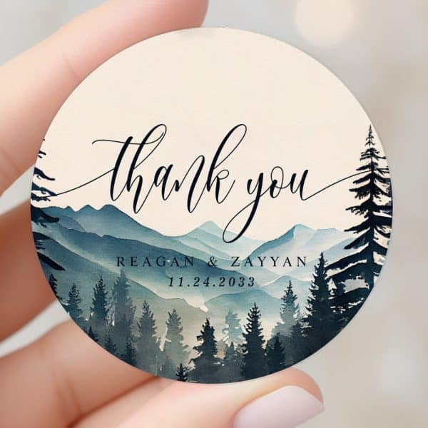 Round Thank You Sticker With Watercolor Mountains And Forest Scene. Reagan &Amp; Zayyan Wedding Date 11.24.2033.