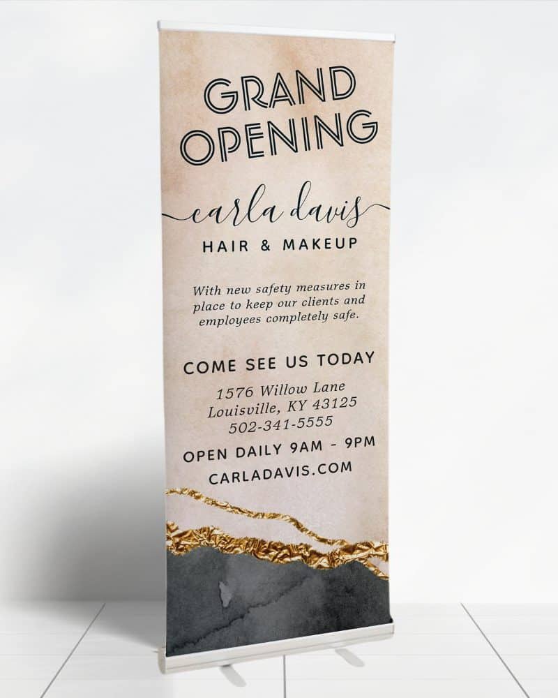 Grand opening retractable banner for Carla Davis Hair & Makeup. The banner includes the business address and hours.