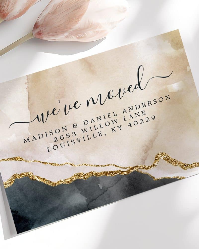 Change of address announcement card with watercolor design and gold accents. The card announces Madison & Daniel Anderson's new address.