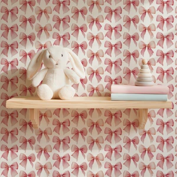 A White Bunny Rabbit Sits On A Shelf Against A Pink Bow Wallpaper.