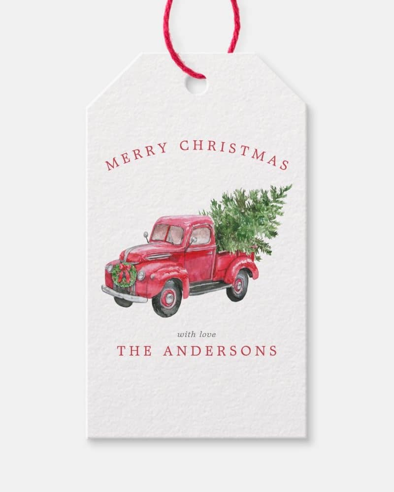 Christmas gift tag featuring a red vintage truck carrying a Christmas tree.