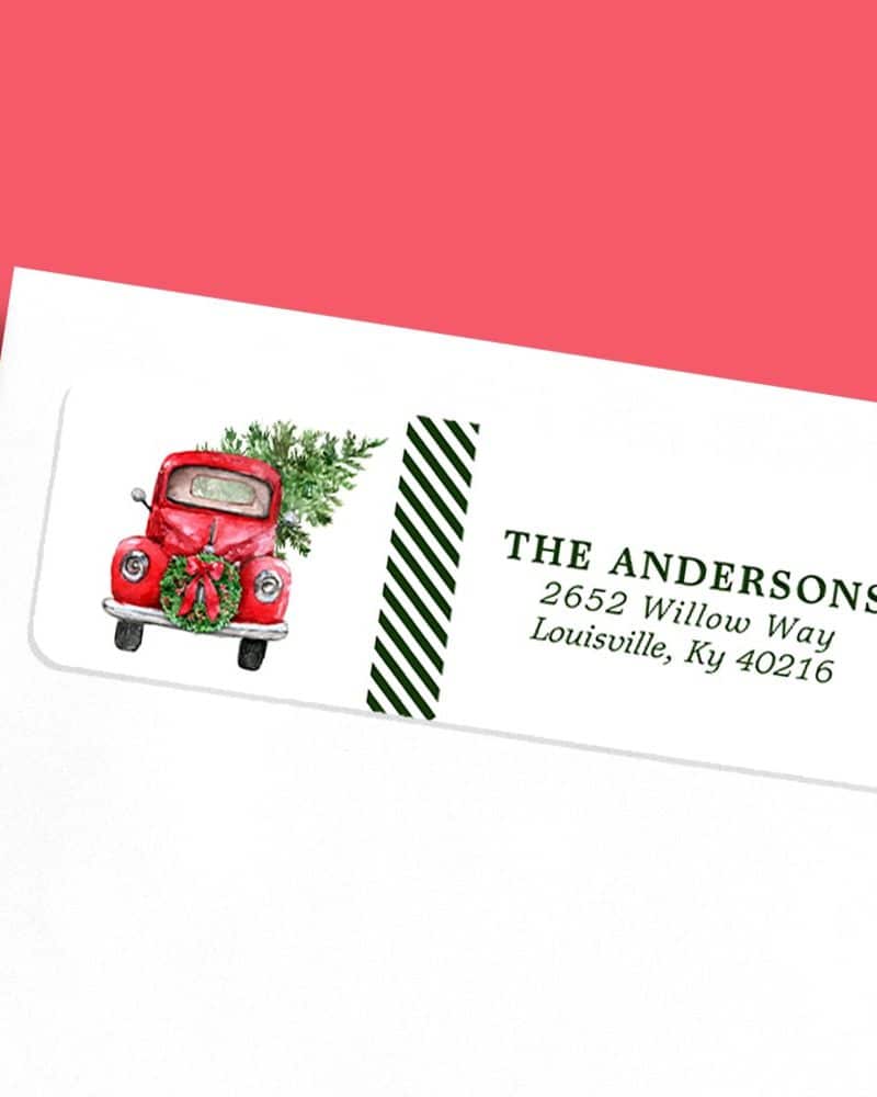 Return address label featuring a red vintage truck carrying a Christmas tree.