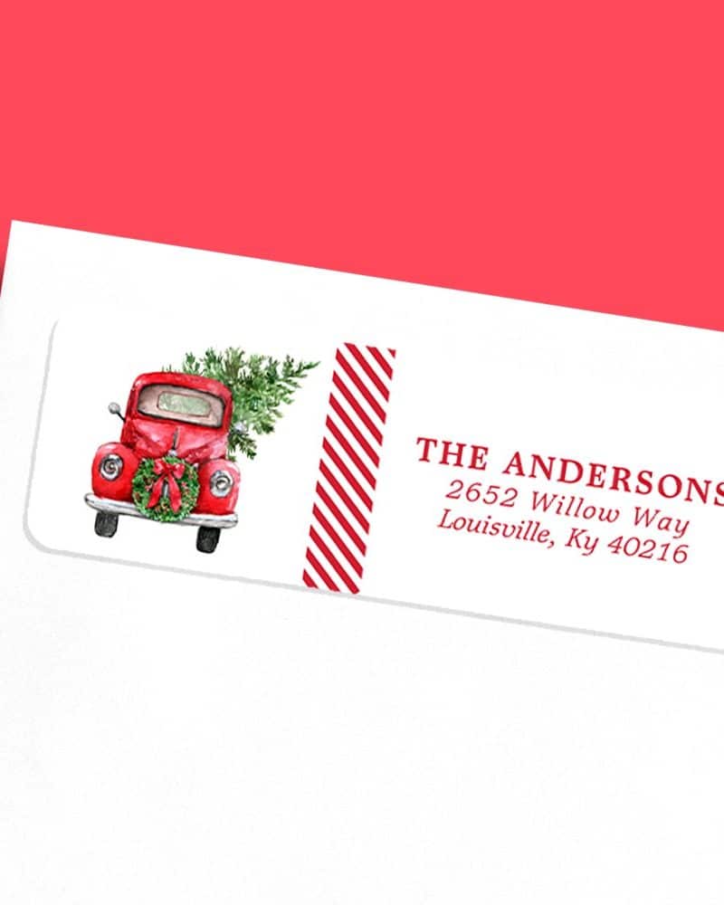 Return address label featuring a red vintage truck carrying a Christmas tree.