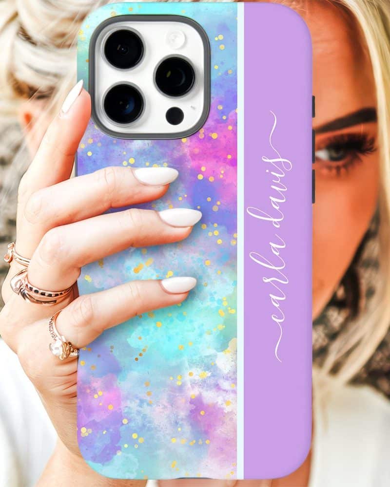 A woman's hand holds up a pastel-colored iPhone case with gold glitter and the name Carla Davis.
