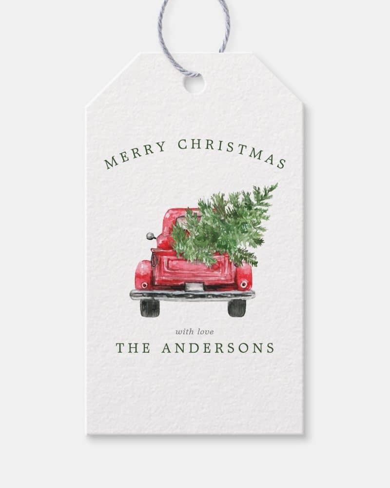 Christmas gift tag featuring a red truck carrying a Christmas tree.