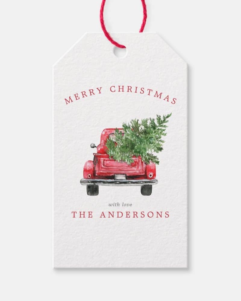Christmas gift tag featuring a red truck carrying a Christmas tree. The Andersons family name is included.