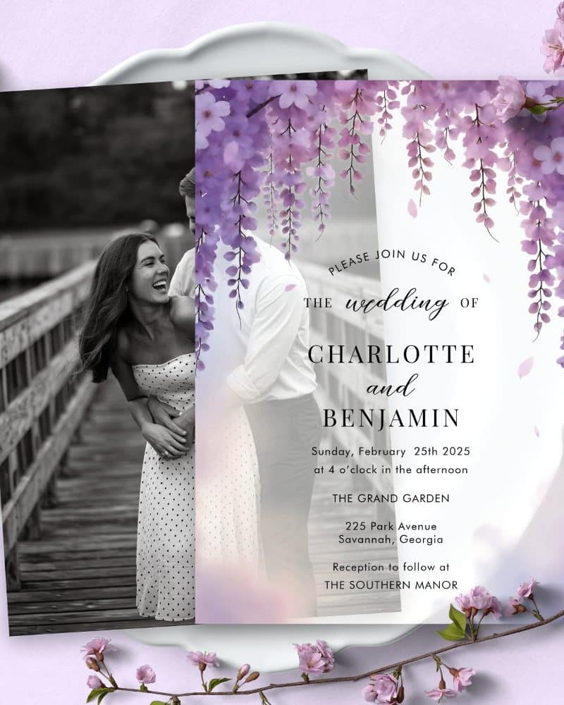 Wedding invitation with a black and white photo of a laughing couple and a purple floral border.