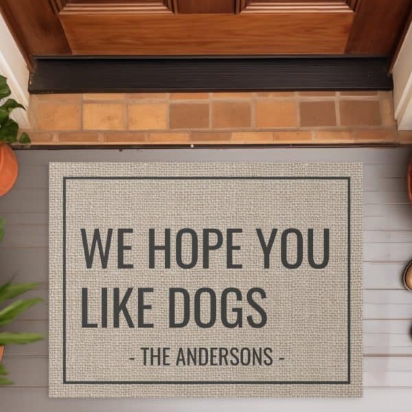 Beige Doormat With The Text We Hope You Like Dogs And The Andersons.