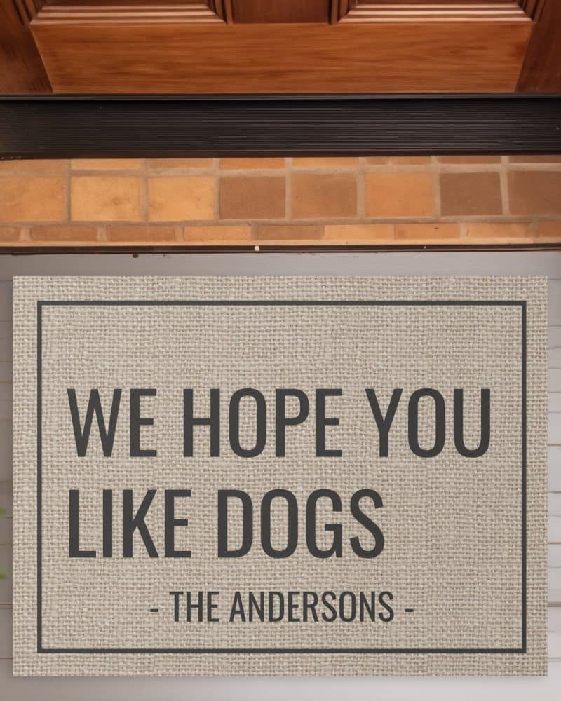 Beige doormat with the text We Hope You Like Dogs and The Andersons.
