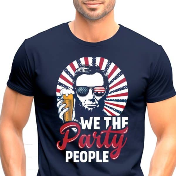 Navy Blue T-Shirt Featuring Abraham Lincoln Wearing Sunglasses And Holding A Beer, Set Against A Red, White, And Blue Sunburst With The Text We The Party People.